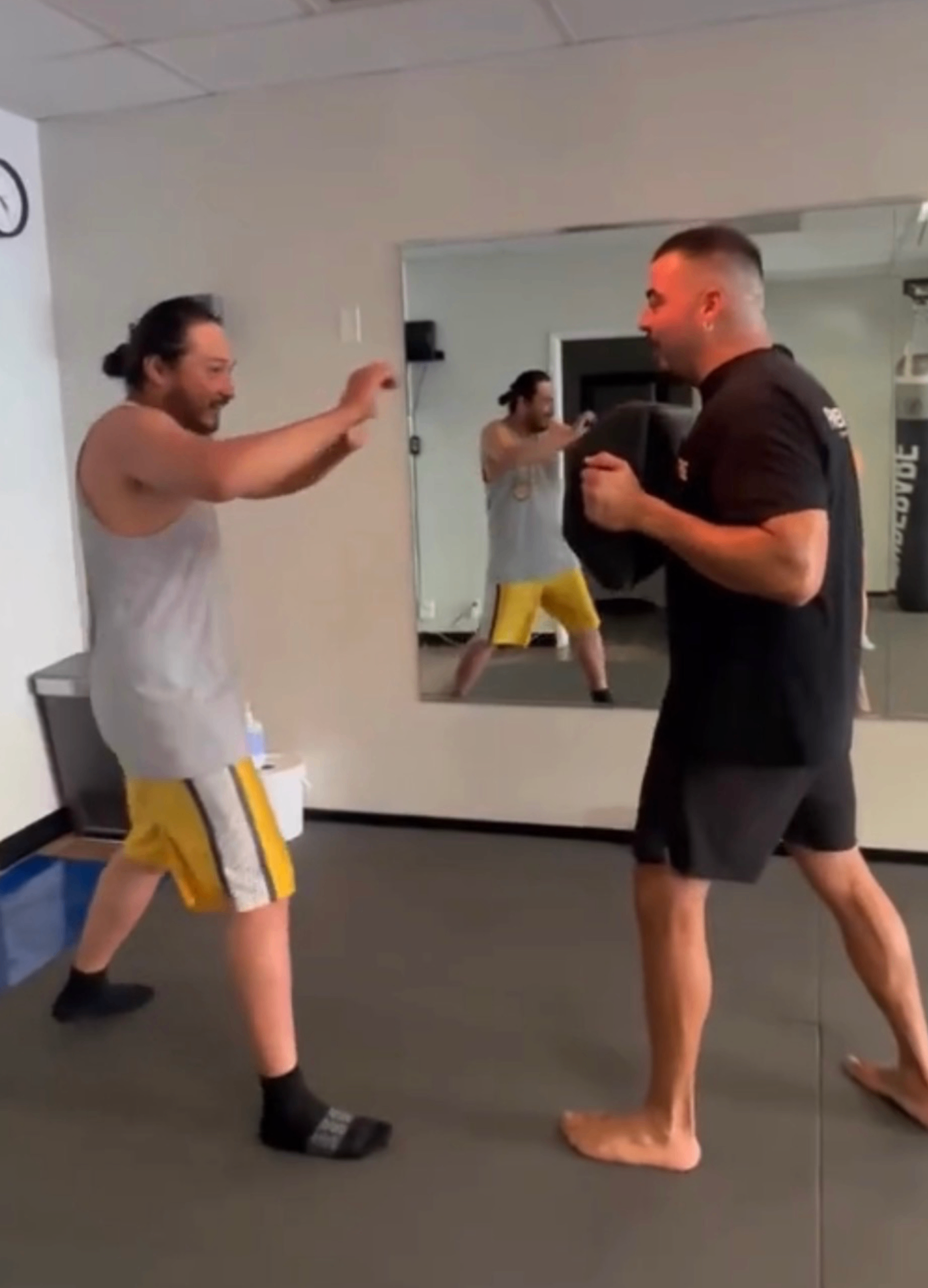 Clayton training boxing with a partner in the gym